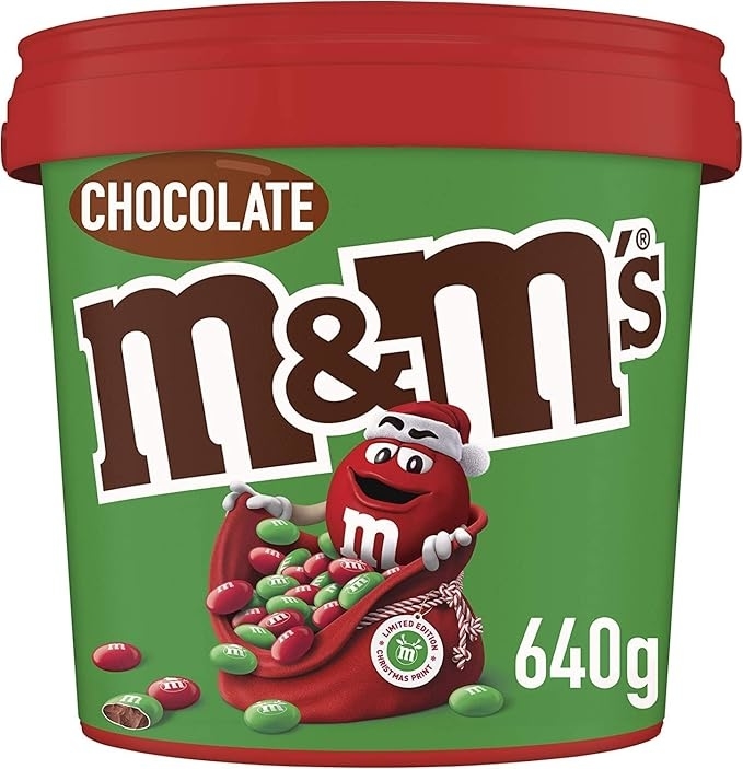 M&amp;amp;M&#x27;s 640g container with holiday design, featuring the red M&amp;amp;M character in a Santa hat holding green and red candies