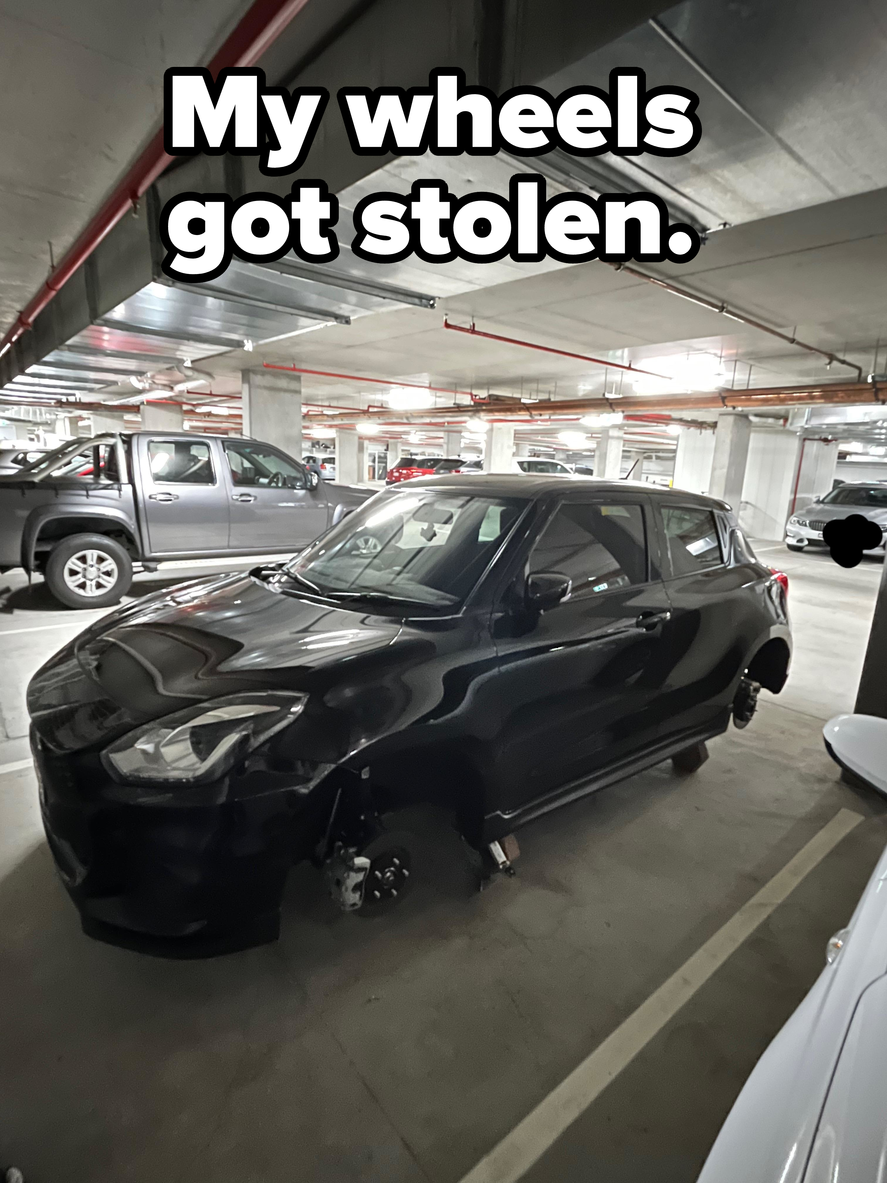 Car parked in a garage with missing wheels