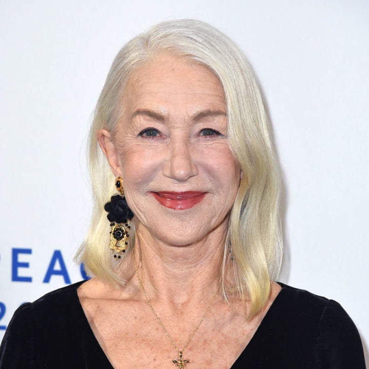 An elegant woman in a black dress with floral earrings and a cross necklace