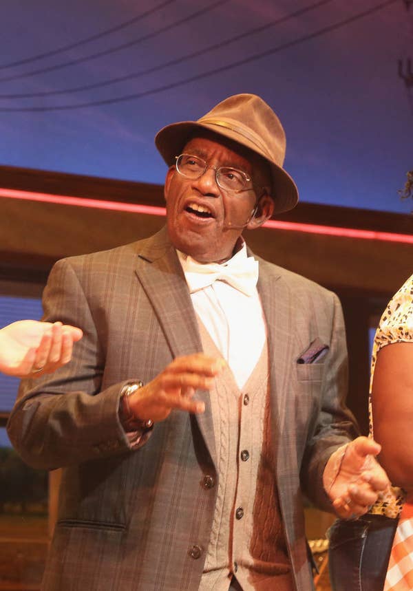 Al in a vintage suit and hat performing on stage