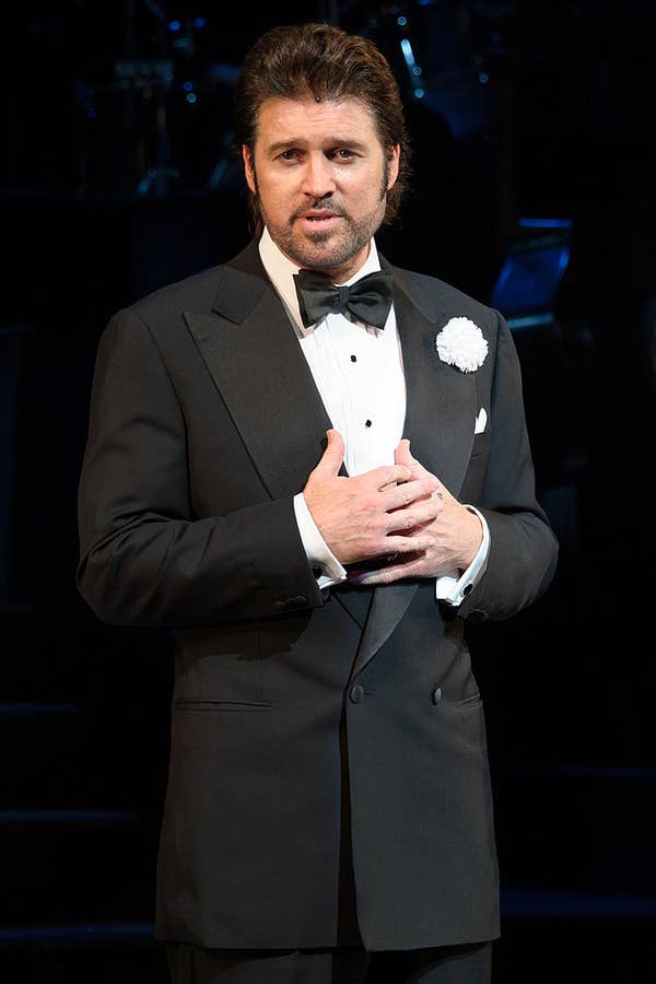 Billy Ray Cyrus in a tux with slicked-back hair onstage