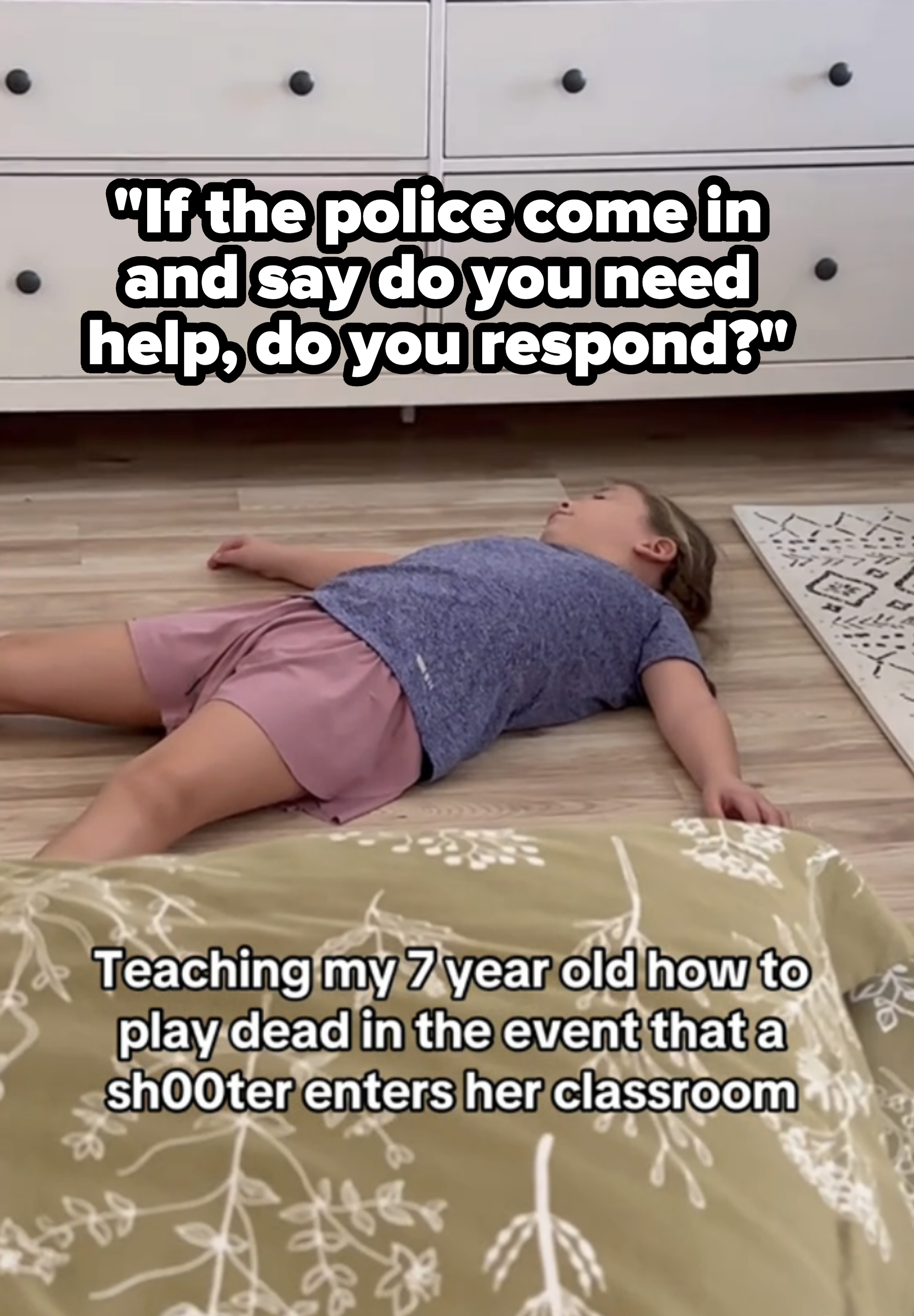 Child lying on wooden floor, practicing playing dead as part of an active shooter drill. Dresser and rug in background. Text on image: "Teaching my 7 year old how to play dead in the event that a shooter enters her classroom."