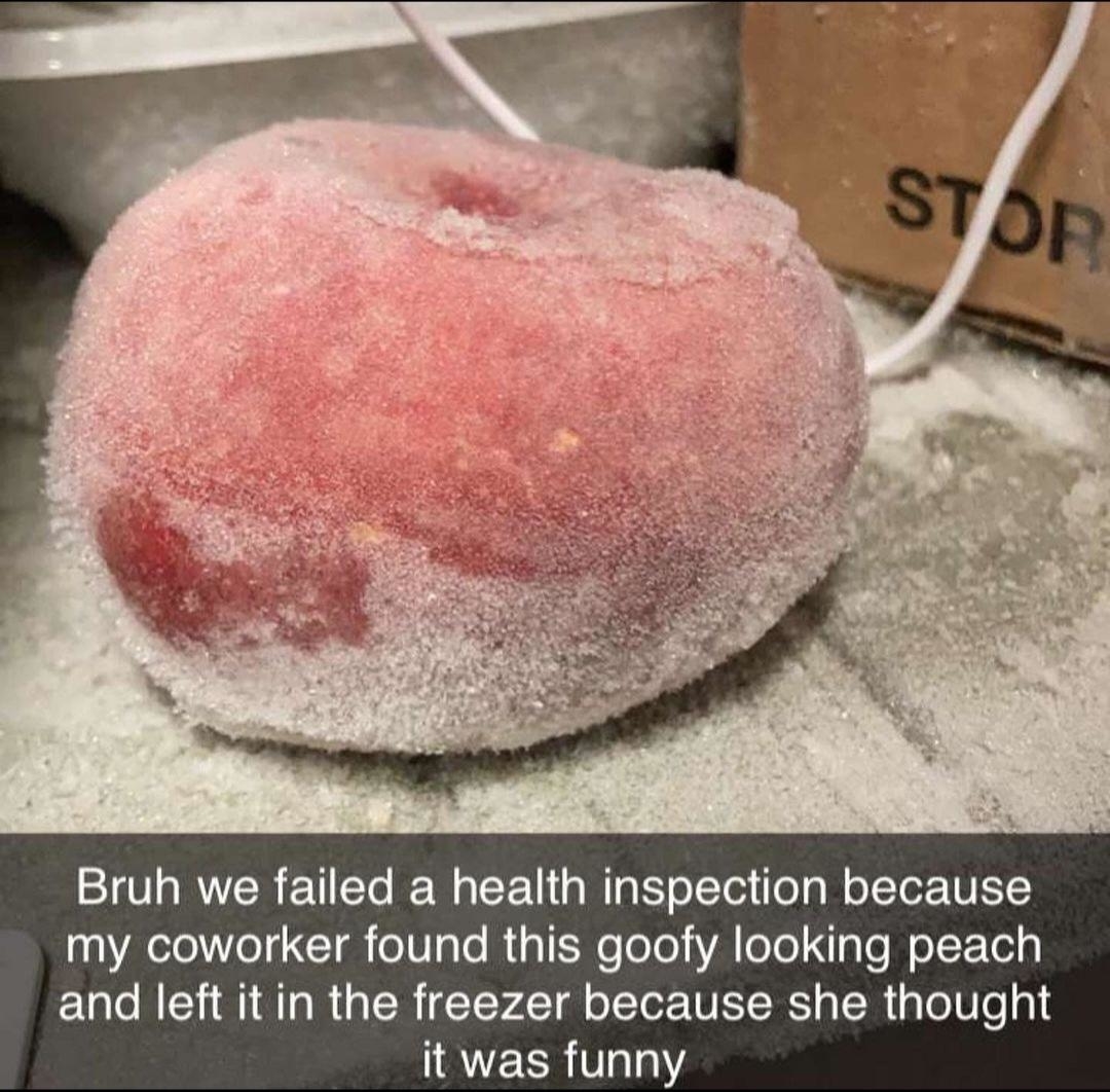 Frost-covered peach in a freezer with a caption about failing a health inspection due to a coworker leaving it there as a joke