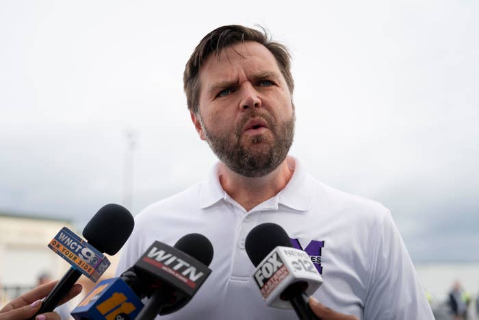 J.D. speaking into multiple mics