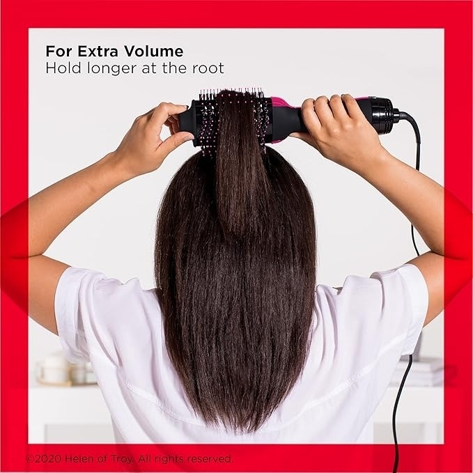 Person using a hairdryer brush for volume, holding longer at the roots. The text suggests styling tips for extra volume