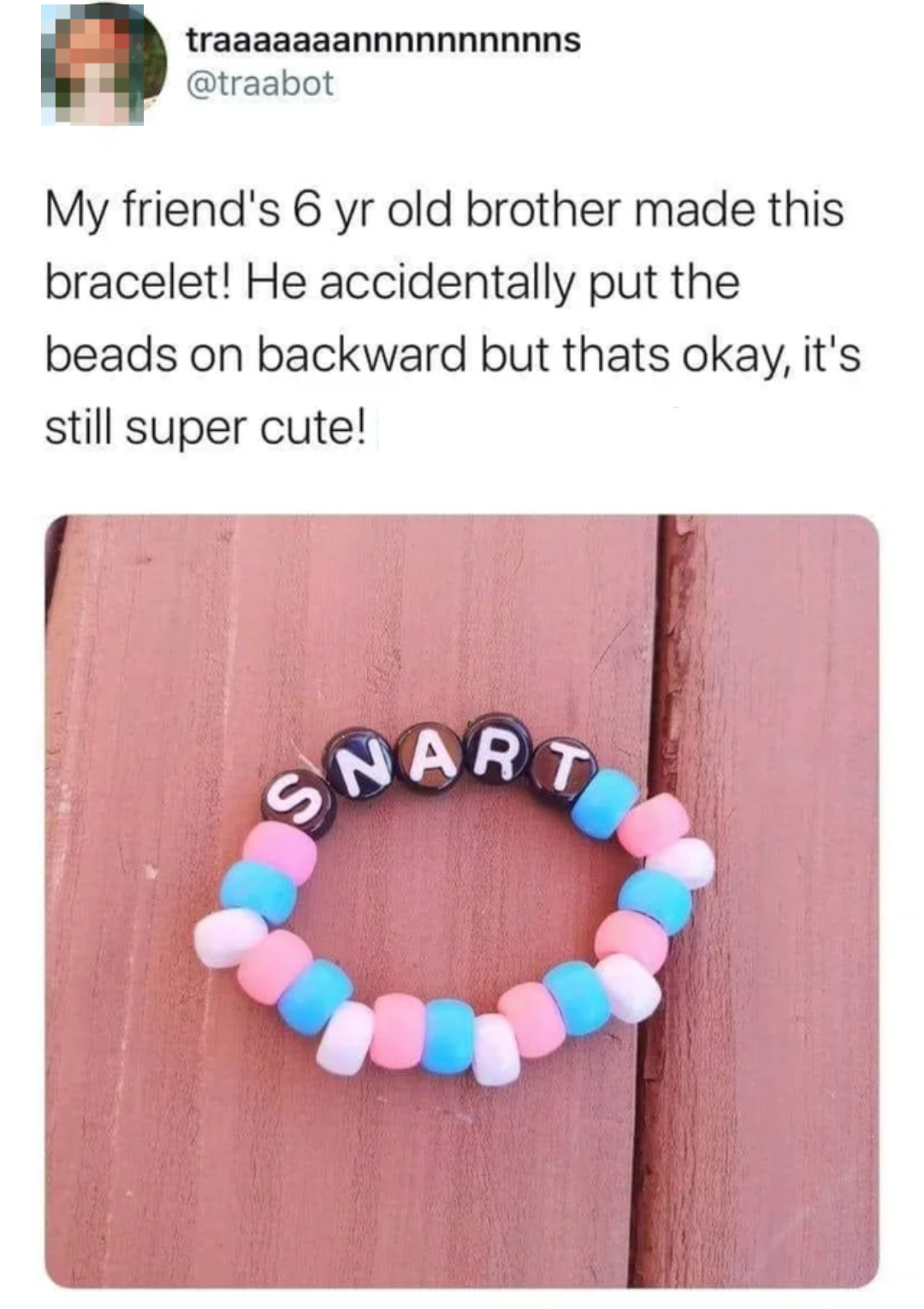 A colorful beaded bracelet spells &quot;SNART&quot; instead of &quot;TRAN&quot;. A social media post praises its cuteness despite the mistake