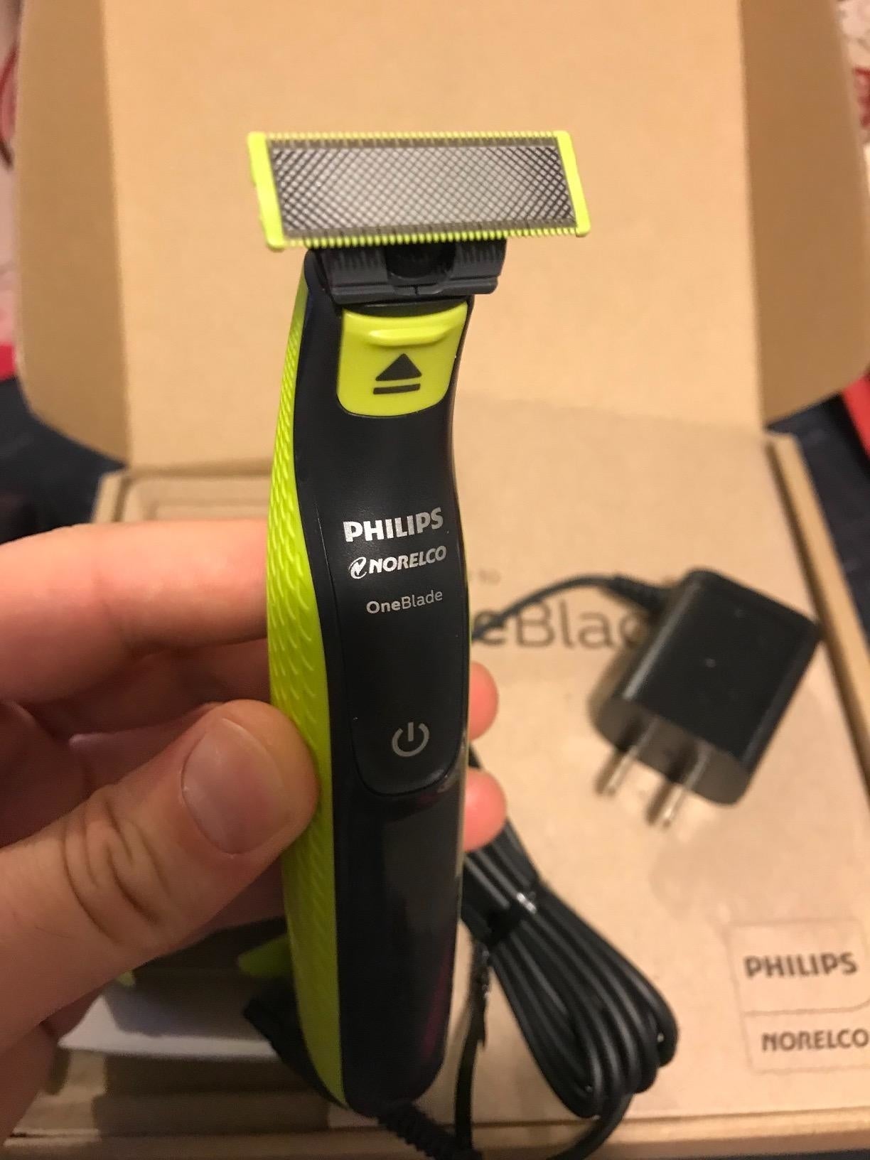 Philips Norelco OneBlade trimmer with charger, packaging successful  background