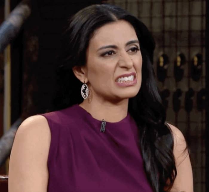 Someone cringes during a talk show