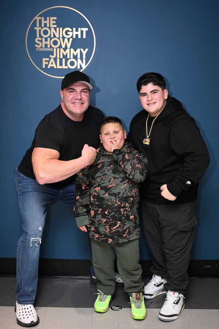 Three unidentified people pose in front of