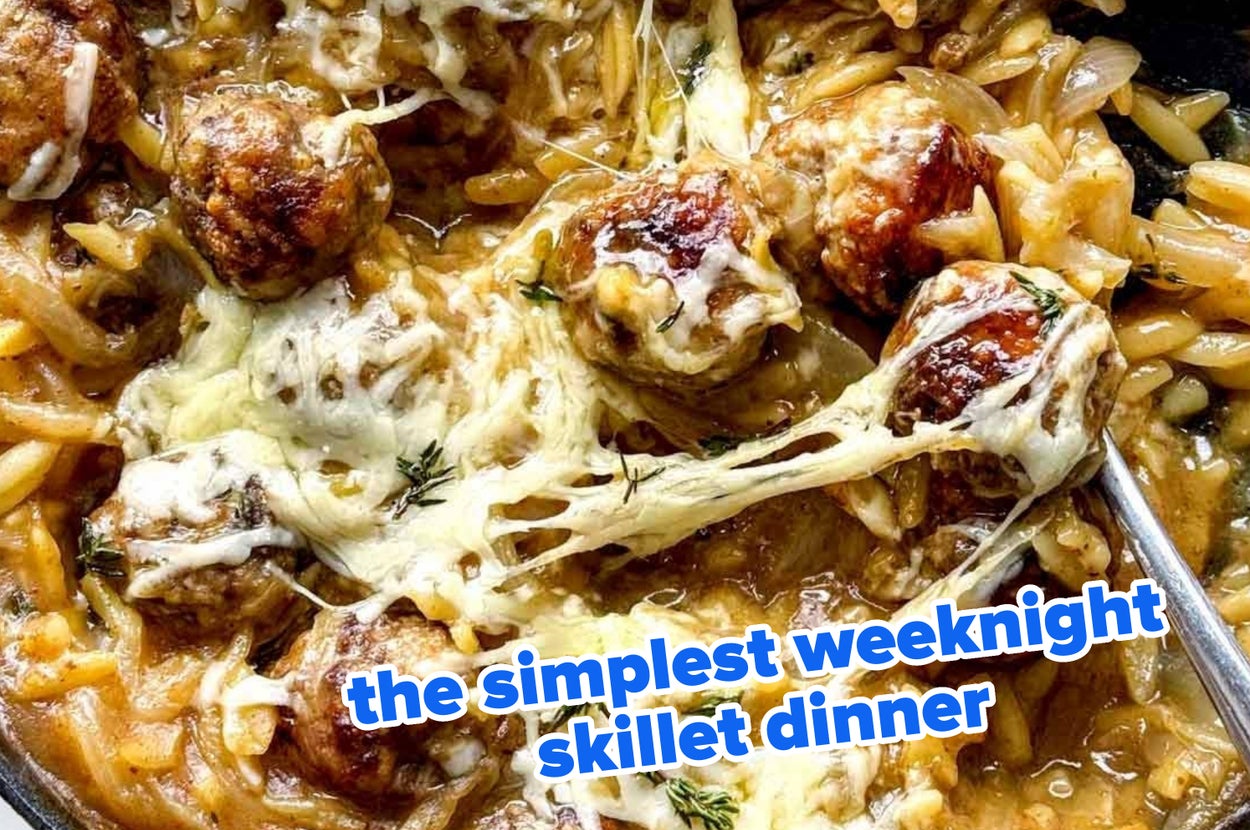 Cheesy orzo skillet with meatballs, topped with melted cheese and herbs. Text: "the simplest weeknight skillet dinner."