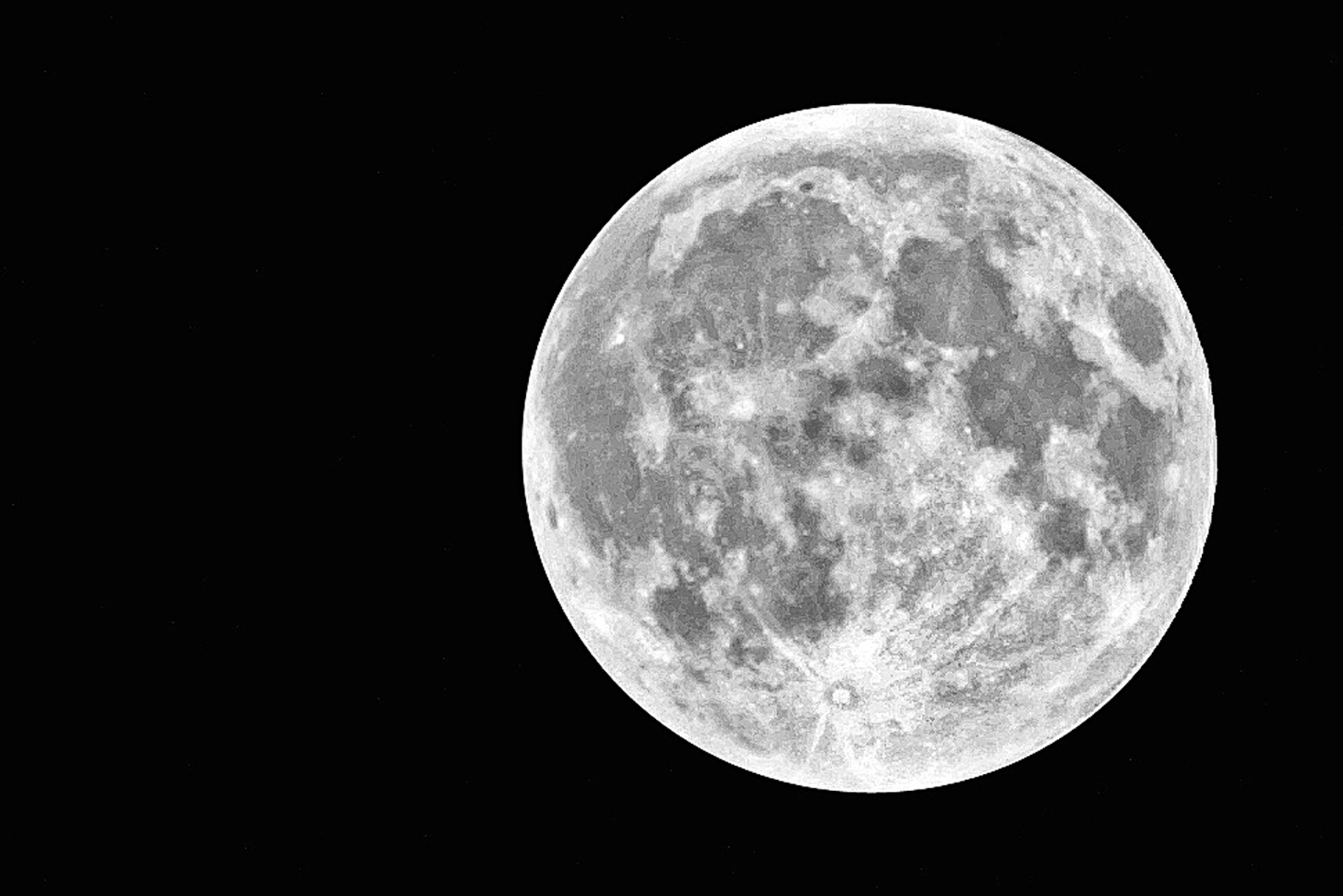 Full moon against a dark sky with visible surface details and craters