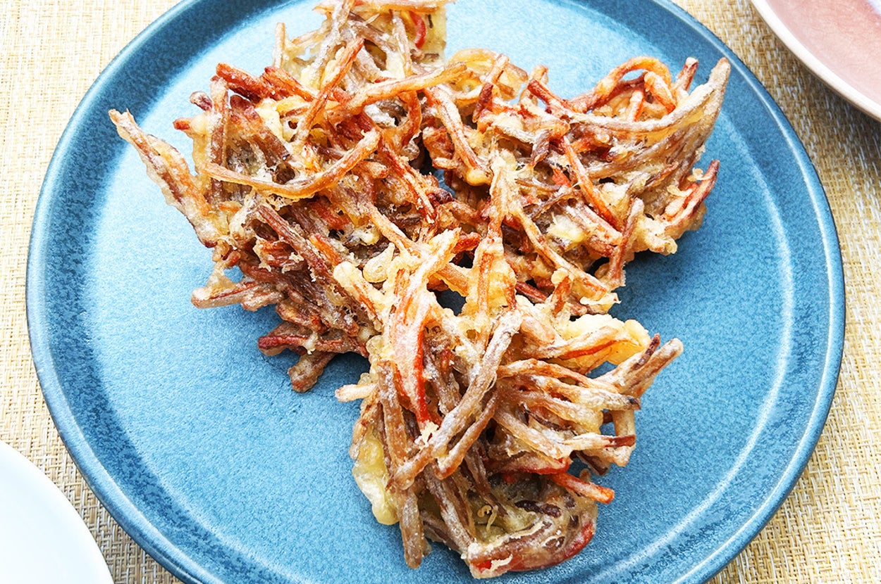 青い皿に盛られたきんぴらごぼうのかき揚げ。サクサクに揚げられています。
