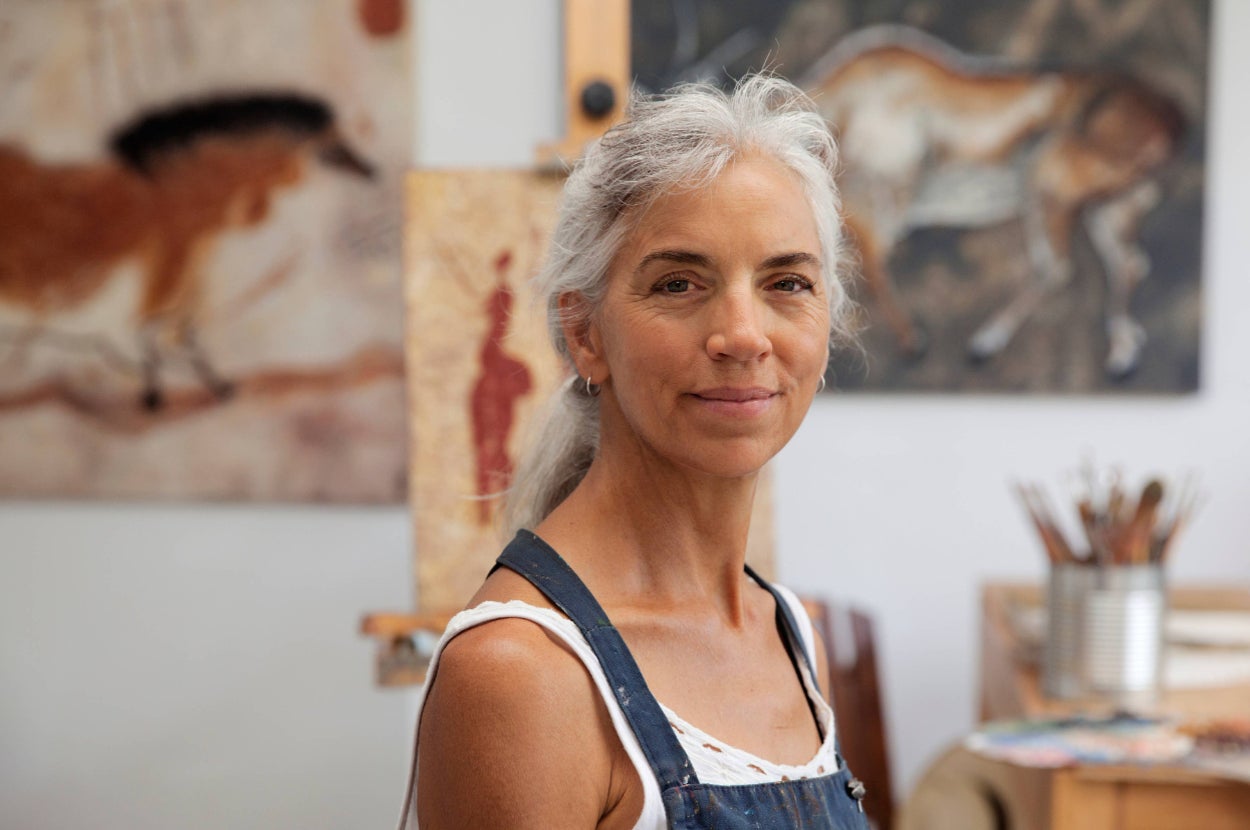 a woman smiles in an art studio