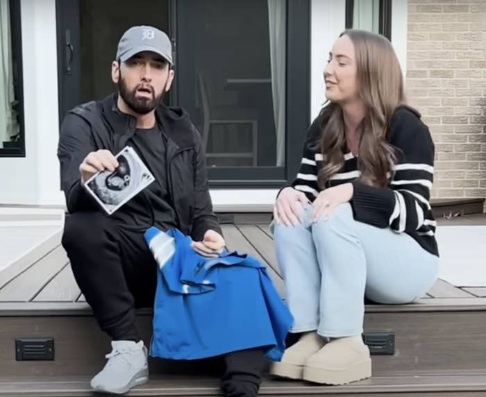Eminem with Hailie Jade sitting on steps outside