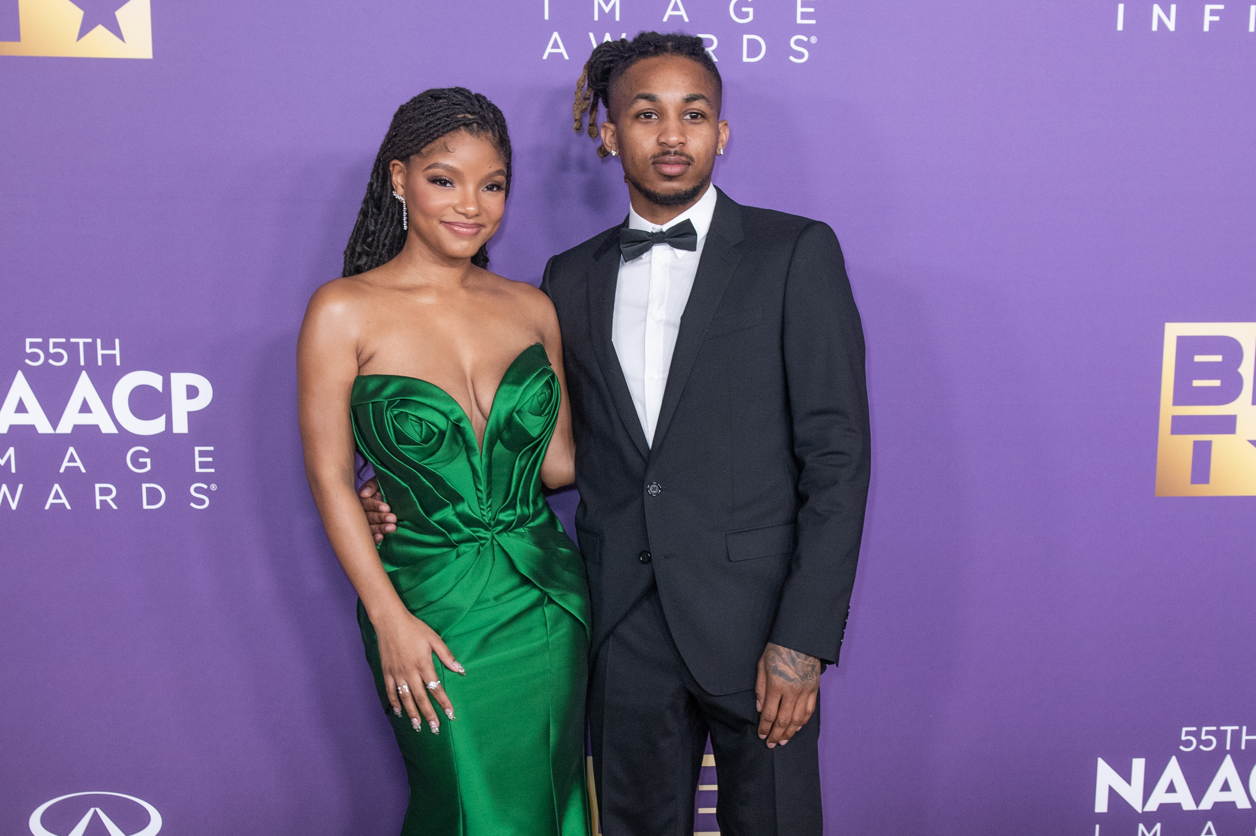 Halle Bailey and DDG on the red carpet. Halle is wearing a strapless dress and DDG is wearing a suit and bow tie