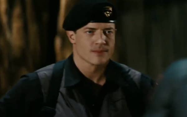 Brendan wearing a beret and uniform is in an outdoor setting, looking determined