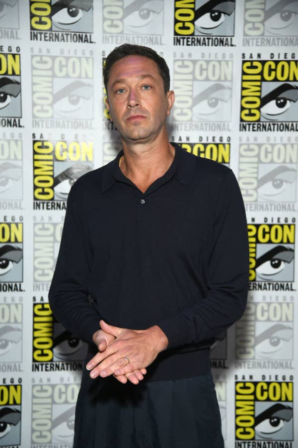 Ebon in a long-sleeved polo and trousers posing at SDCC