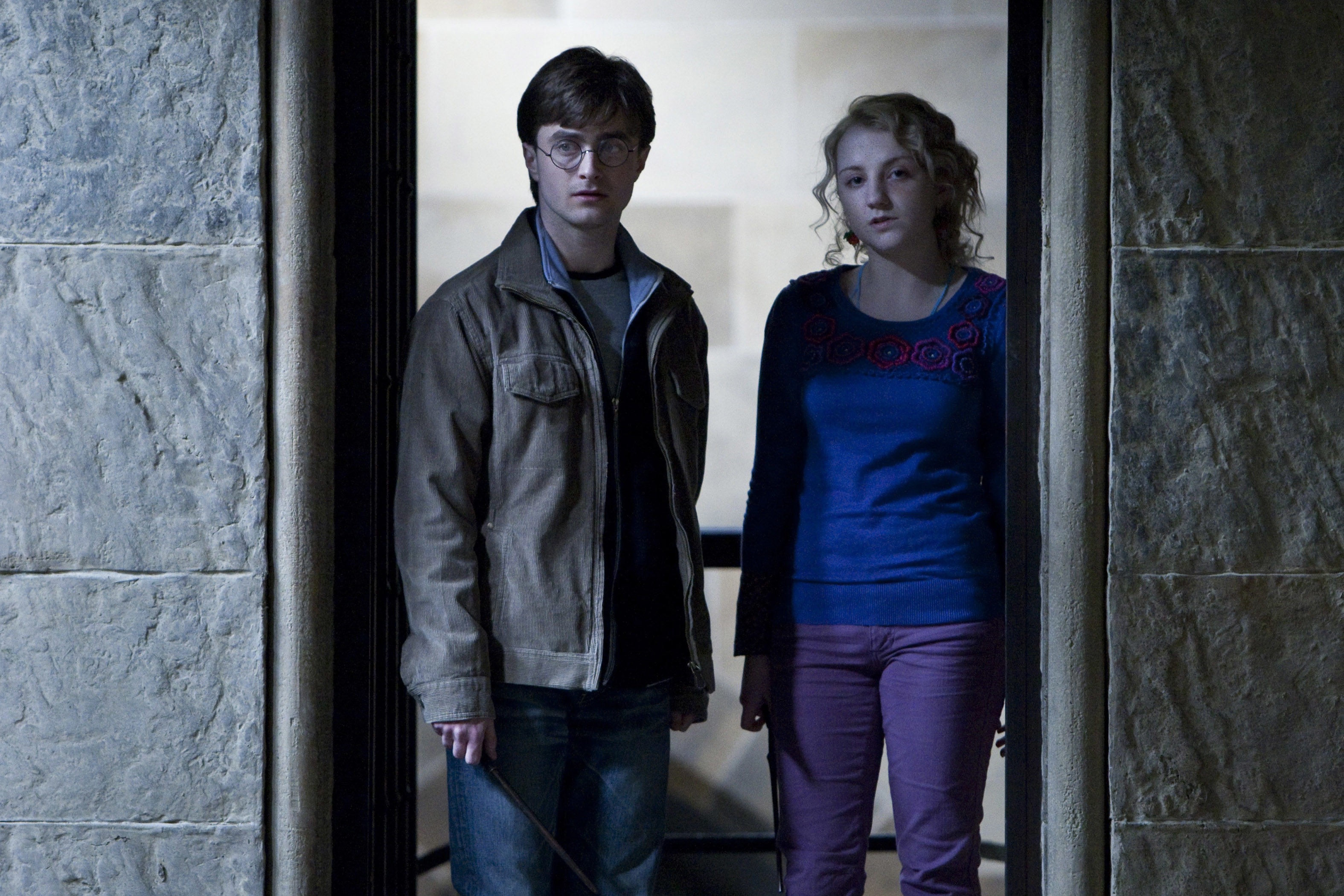 Harry Potter and Luna Lovegood standing together in a doorway, looking forward