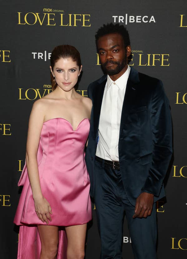 Two people at a &quot;Love Life&quot; event. The woman wears a strapless pink gown, and the man wears a dark suit