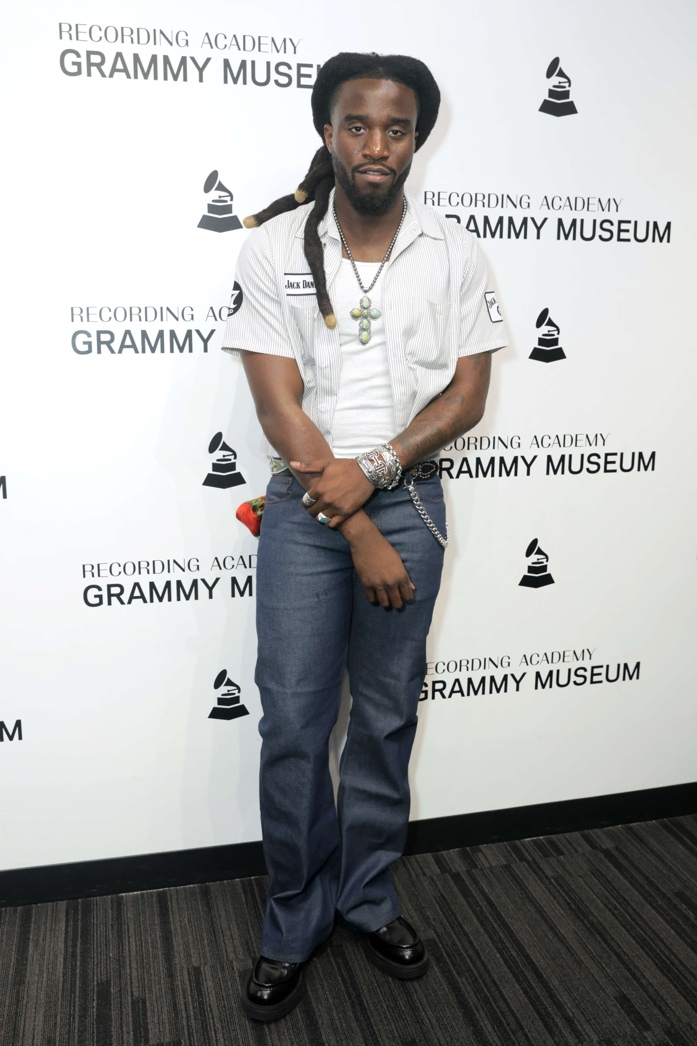 Man in a short-sleeve shirt and jeans poses at the Grammy Museum event