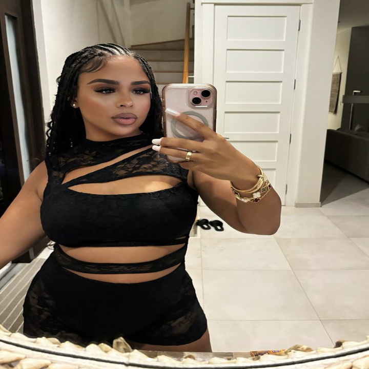 Sheawna Weathersby takes a selfie in a dress with cutouts and layered bracelets