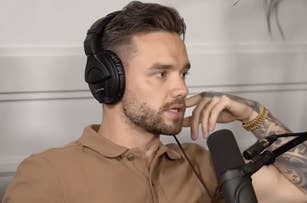 Liam Payne with short dark hair and a beard wearing headphones and a brown polo shirt, speaking into a microphone, appears to be in a podcast setting