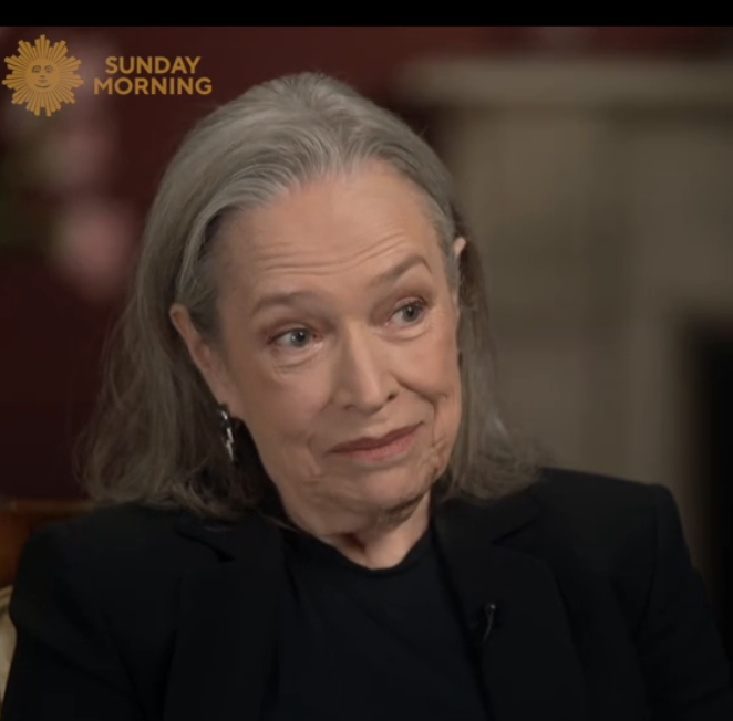 Kathy Bates with shoulder-length hair sits for an interview on &quot;Sunday Morning,&quot; wearing a dark top and blazer