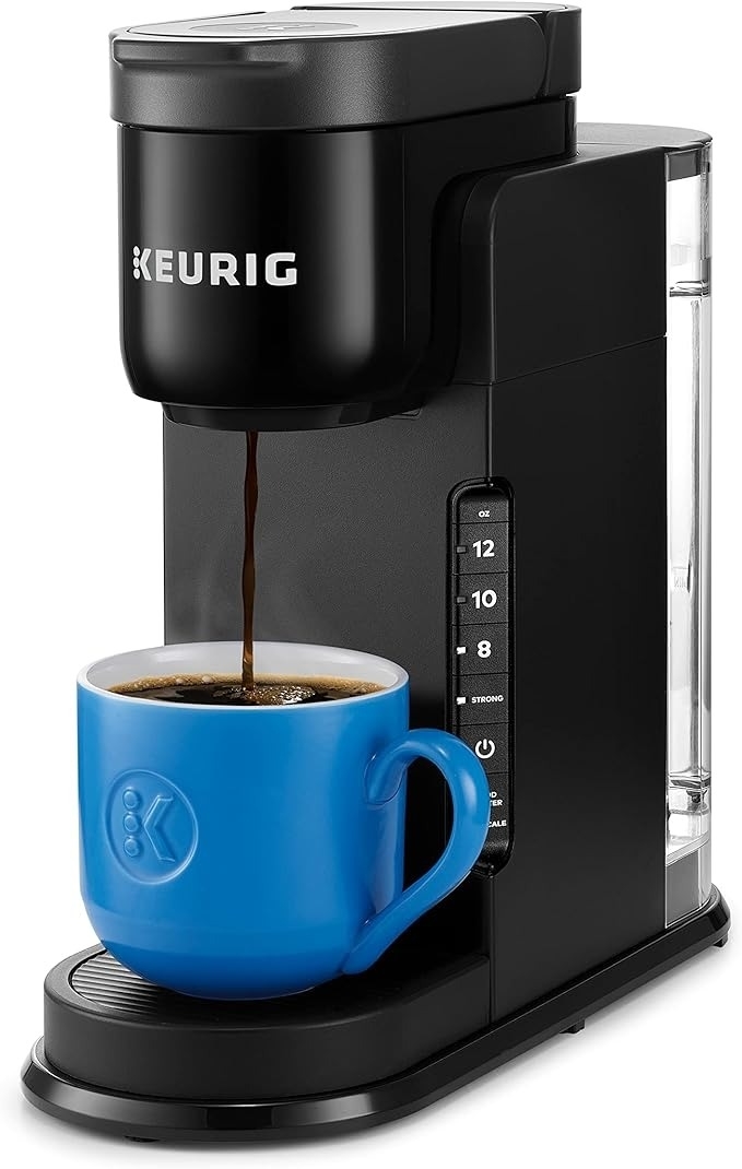 Single-serve Keurig coffee maker with a blue mug brewing coffee, used in a shopping article about kitchen appliances