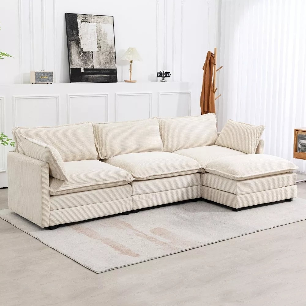 Modern beige sectional sofa on a light rug in a stylish living room with minimalist decor