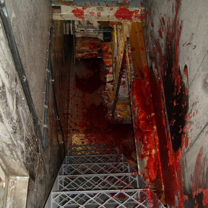 Stairwell covered in an unidentified red substance, creating a dramatic and chaotic scene