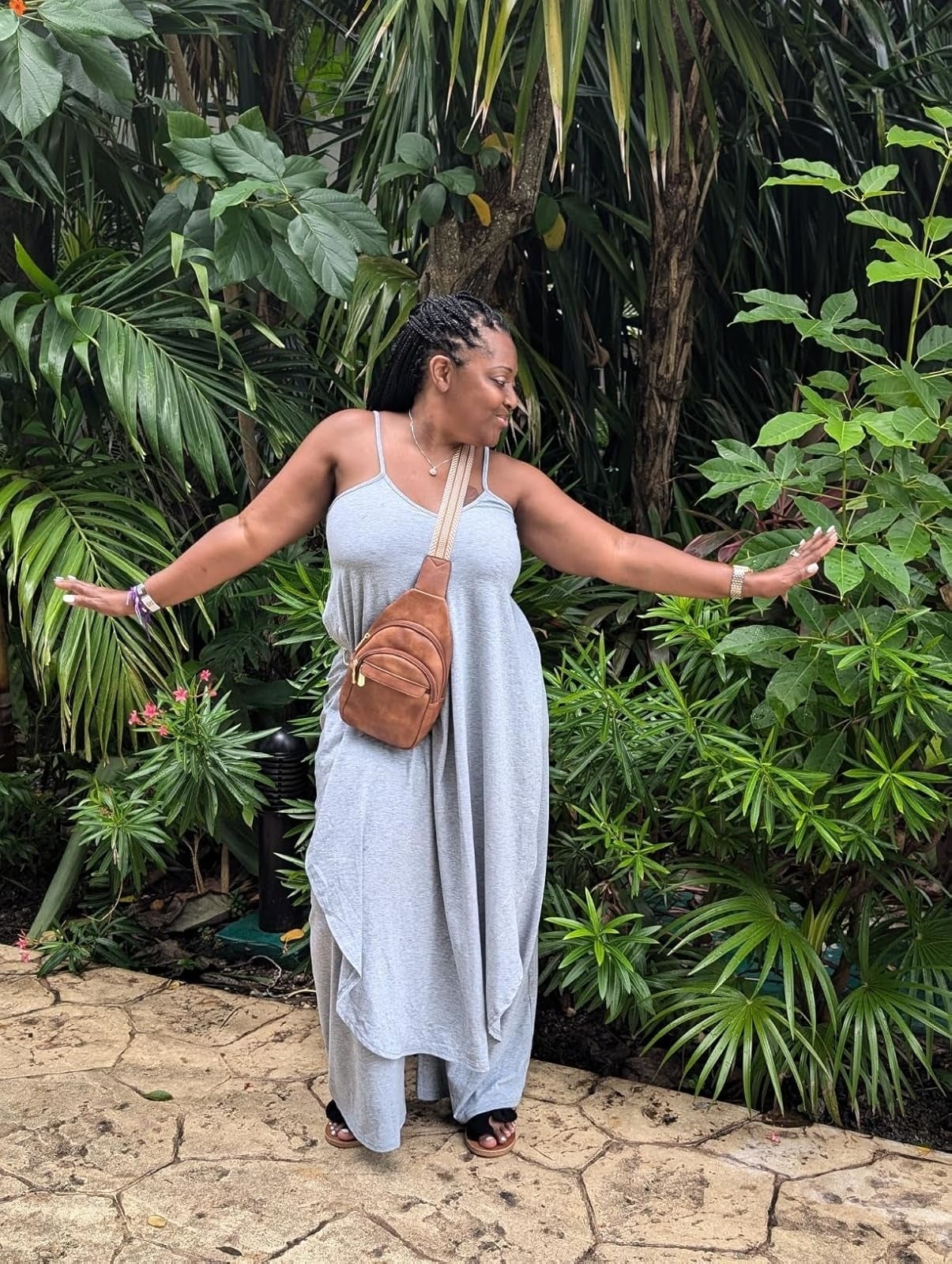 reviewer successful  a casual maxi formal  poses with a crossbody container  surrounded by lush plants