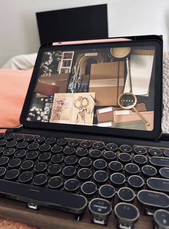 black retro benignant typewriter Bluetooth keyboard attached to an iPad