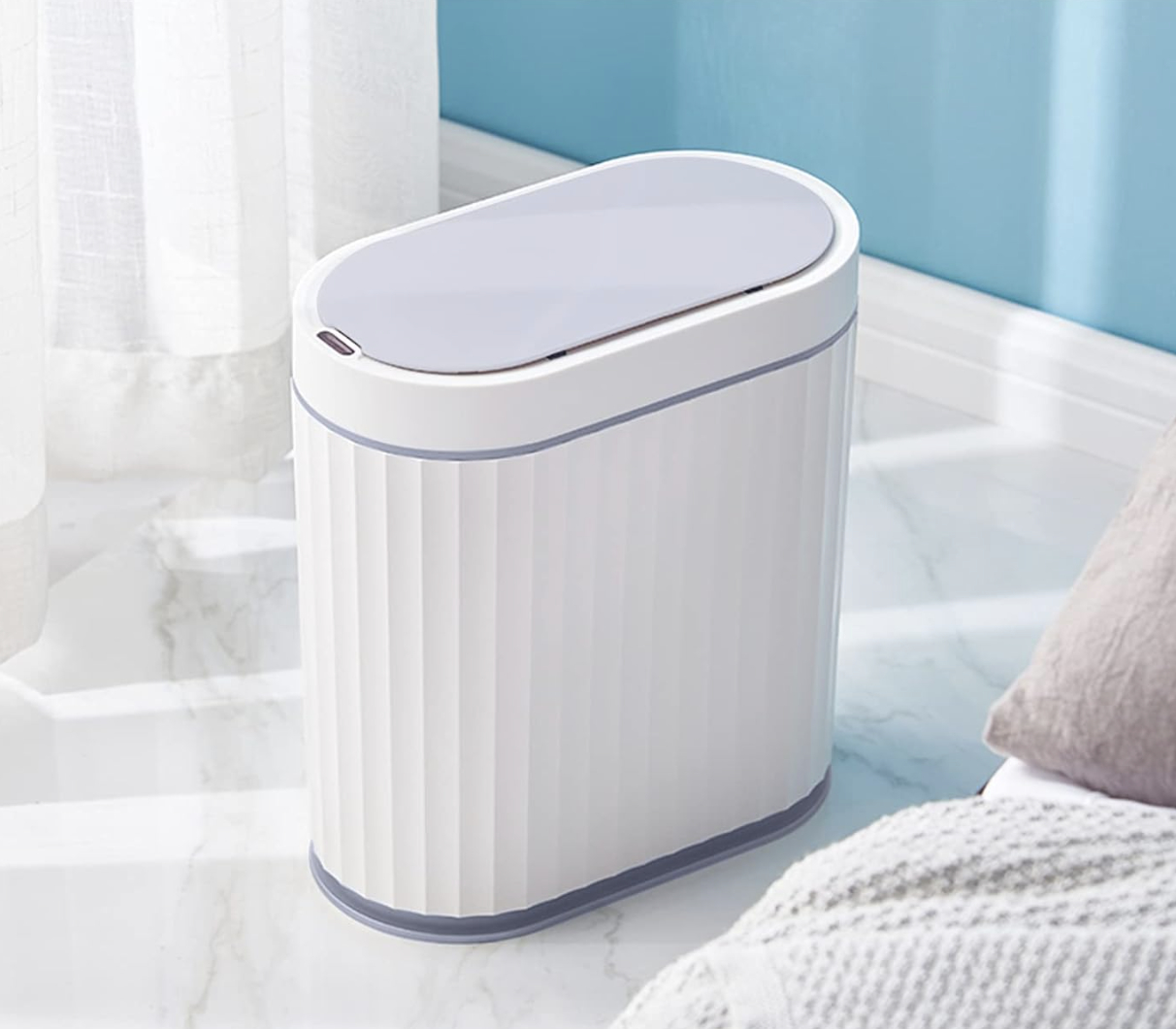 Sleek, modern trash can with a lid, placed in a bright, tidy room setting