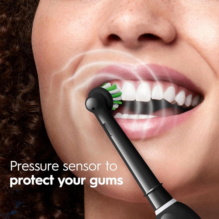 Person brushing teeth with an electric toothbrush. Text reads: "Pressure sensor to protect your gums."