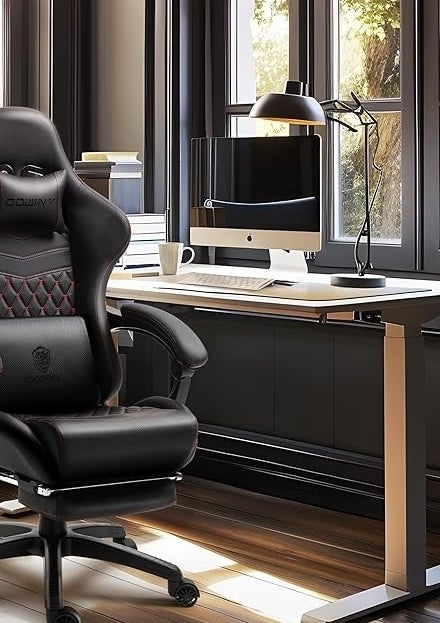 Ergonomic gaming chair in a stylish office with a computer on a desk by large windows. Dowinx logo visible on the chair