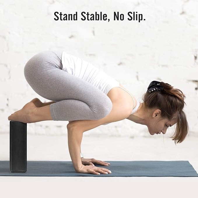 Woman in yoga pose balancing on product; text reads &quot;Stand Stable, No Slip.&quot;