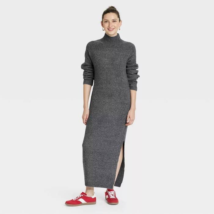 Model in grey dress and red and white shoes