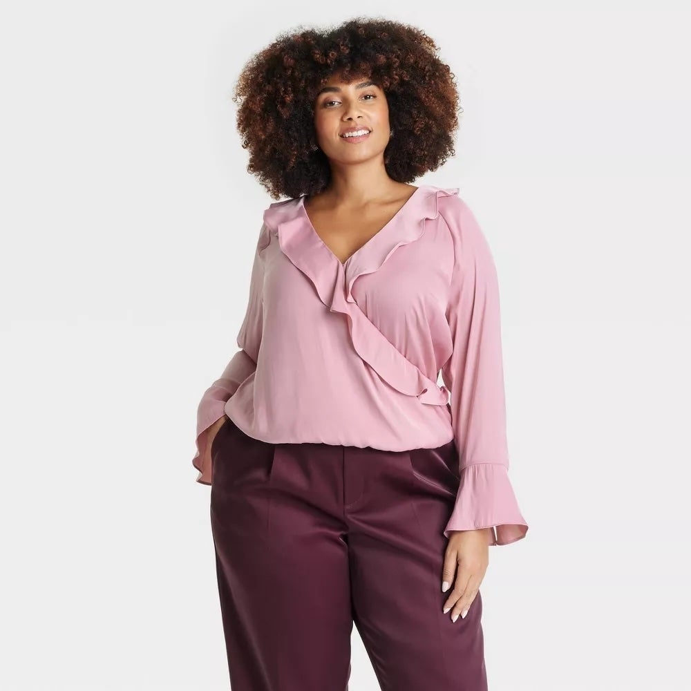 model wearing pink top with red pants