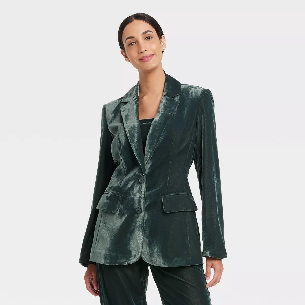 A person wearing a stylish velvet suit
