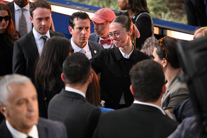 People in formal attire engaging in conversation at a public event