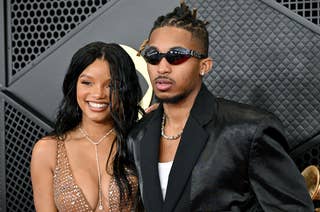 Halle Bailey and DDG on the red carpet; one wearing a sparkling, plunging dress, the other in a tailored black suit with sunglasses