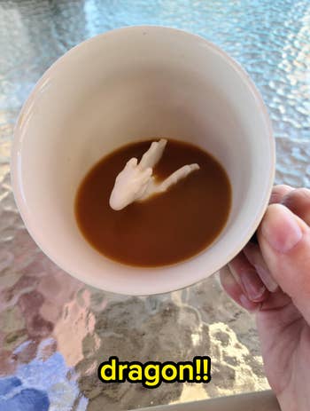 Coffee cup with a horse-shaped cream pouring into the liquid
