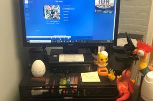 a reviewer photo of a monitor sitting on top of the black multi-drawer organizer stand