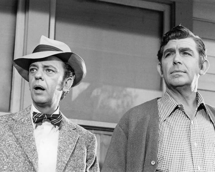 Don Knotts in a suit, bowtie, and hat, and Andy Griffith in a patterned shirt and jacket