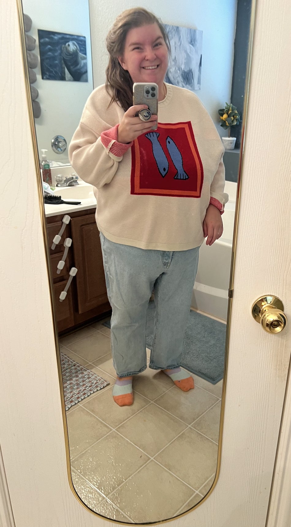 Person successful  a cozy sweater with a food  plan  and escaped   jeans, taking a reflector  selfie successful  a bathroom