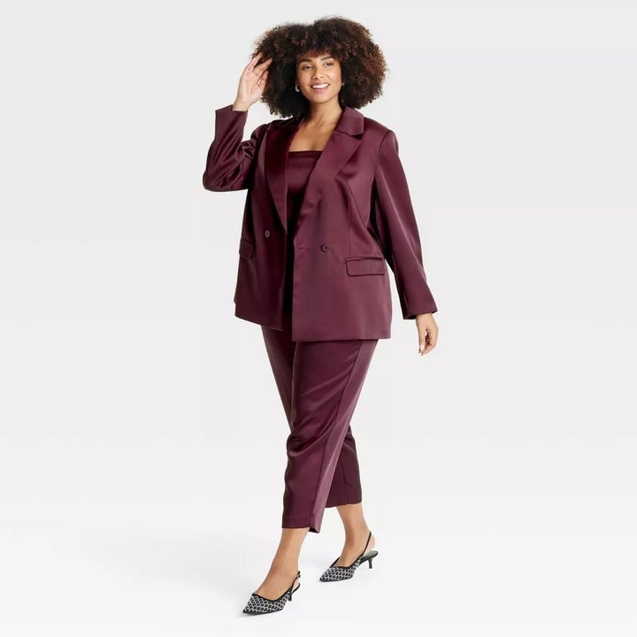 model in a stylish tailored suit with a double-breasted blazer and cropped pants