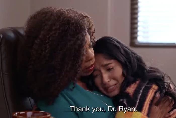 Two people embrace in an emotional moment, sitting in an office. Subtitles read, &quot;Thank you, Dr. Ryan.&quot;