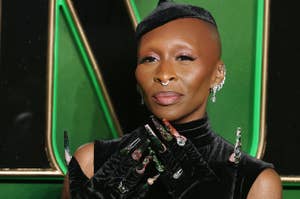 Cynthia Erivo wearing black gloves with long decorative manicure visible, showing her hands at the "Wicked" London premiere