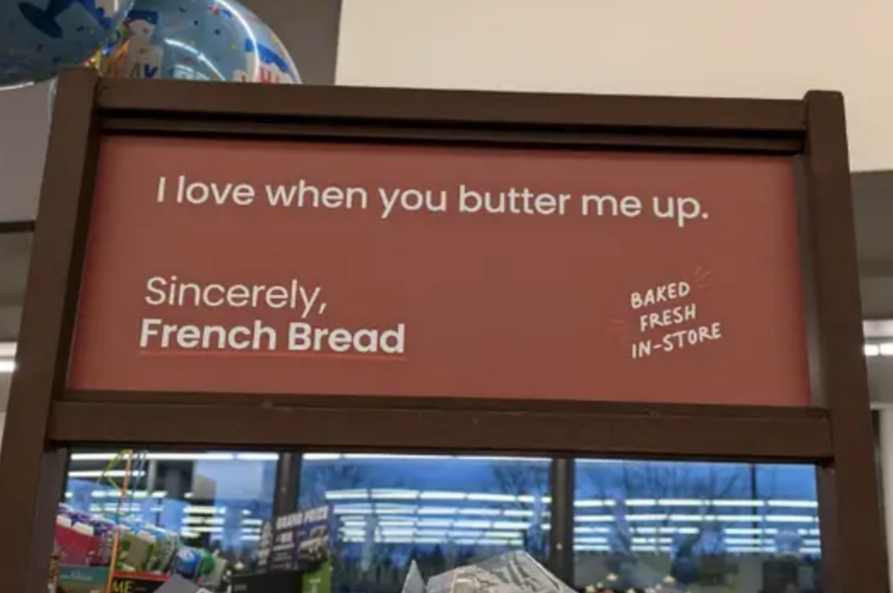 Sign with text: "I love when you butter me up. Sincerely, French Bread." Baked fresh in-store