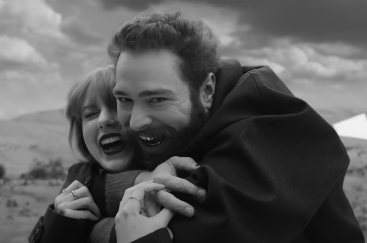 Taylor Swift and Post Malone embracing and smiling in the Fortnight music video